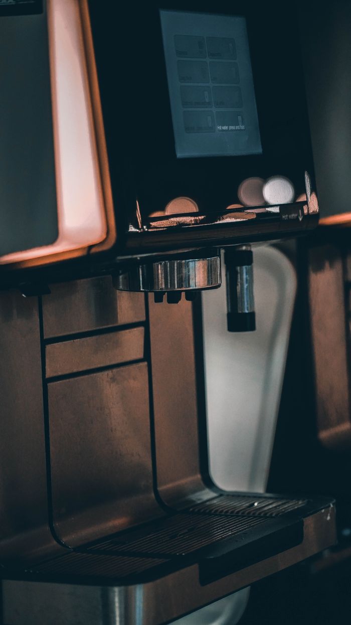 Close-up of a sleek, modern coffee machine with digital display.